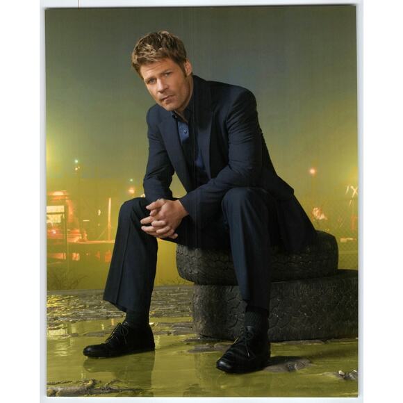 V Joel Gretsch Press Photo Actor Seated on Tires in Urban Night Scene - Picture 1 of 2